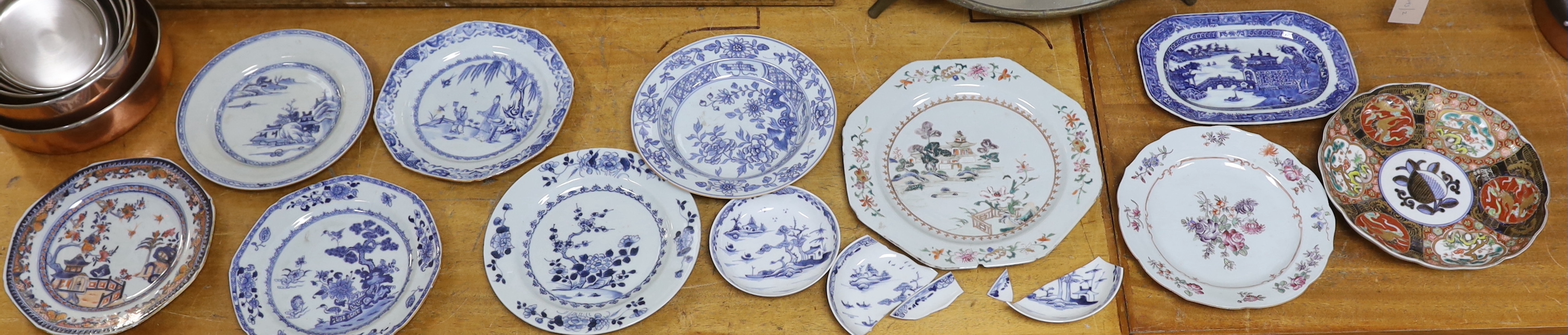 A group of 18th century Chinese porcelain plates and saucers, mostly blue and white and an octagonal famille rose example, together with three Japanese dishes, largest 27cm in diameter